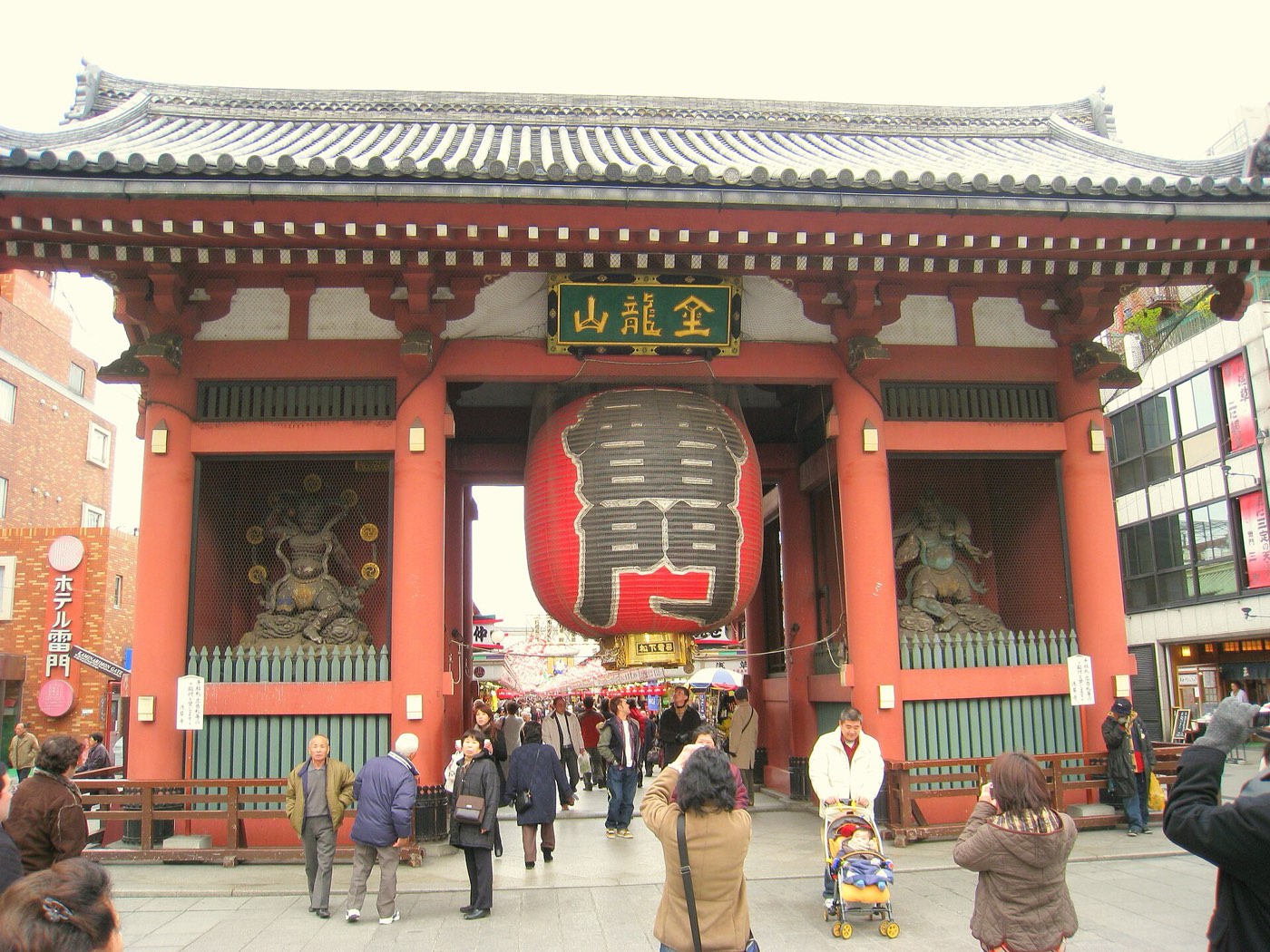 The Kaminarimon gate of Sensō-ji temple with its giant red lantern, visitors passing beneath