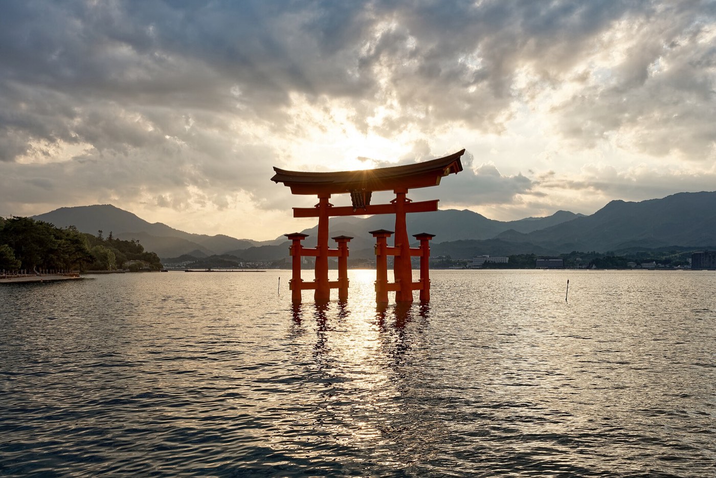 The great torii of Itsukushima Shrine standing in the sea at sunset